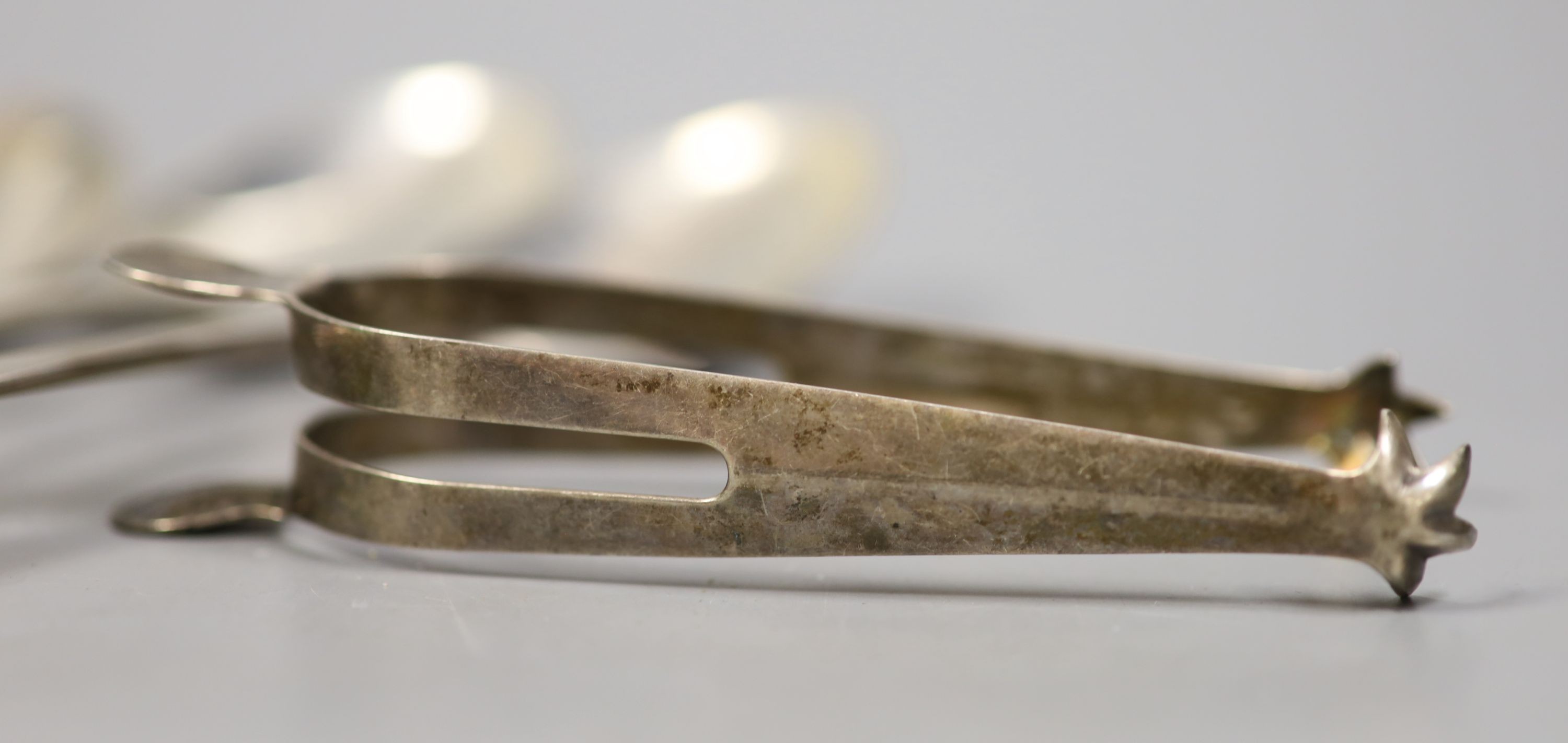 Four various George III silver Old English pattern tablespoons, a later silver salt and pair of silver sugar tongs, 11oz.